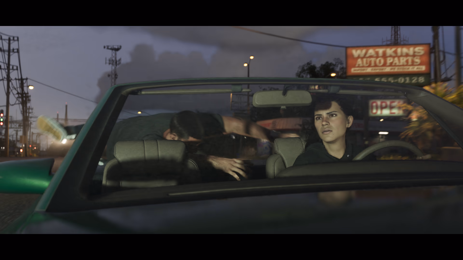 A green four-door sedan moving through Leonida traffic in official GTA 6 footage