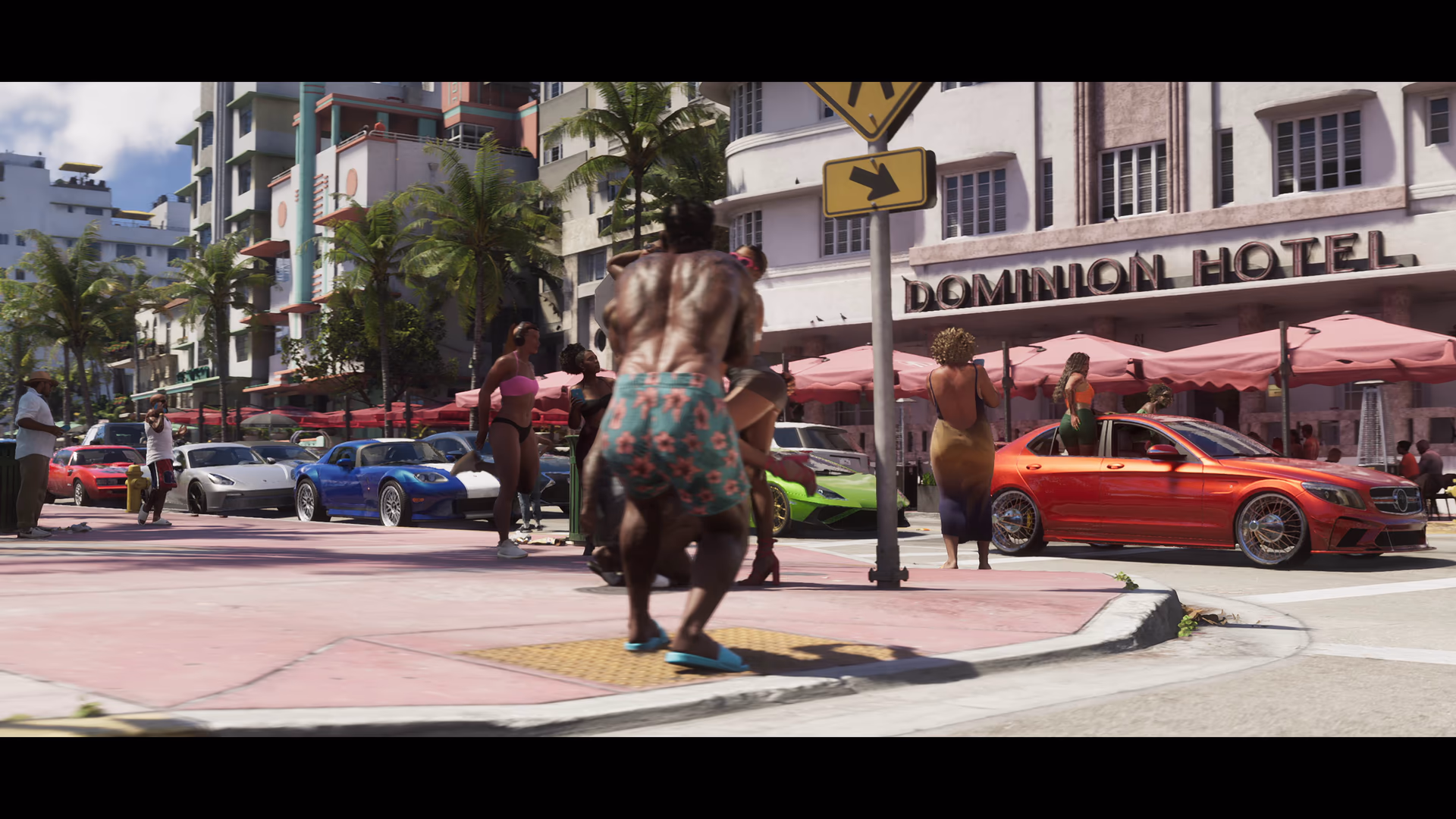 A red sedan and bright green supercar outside an Oceanview hotel in official GTA 6 footage