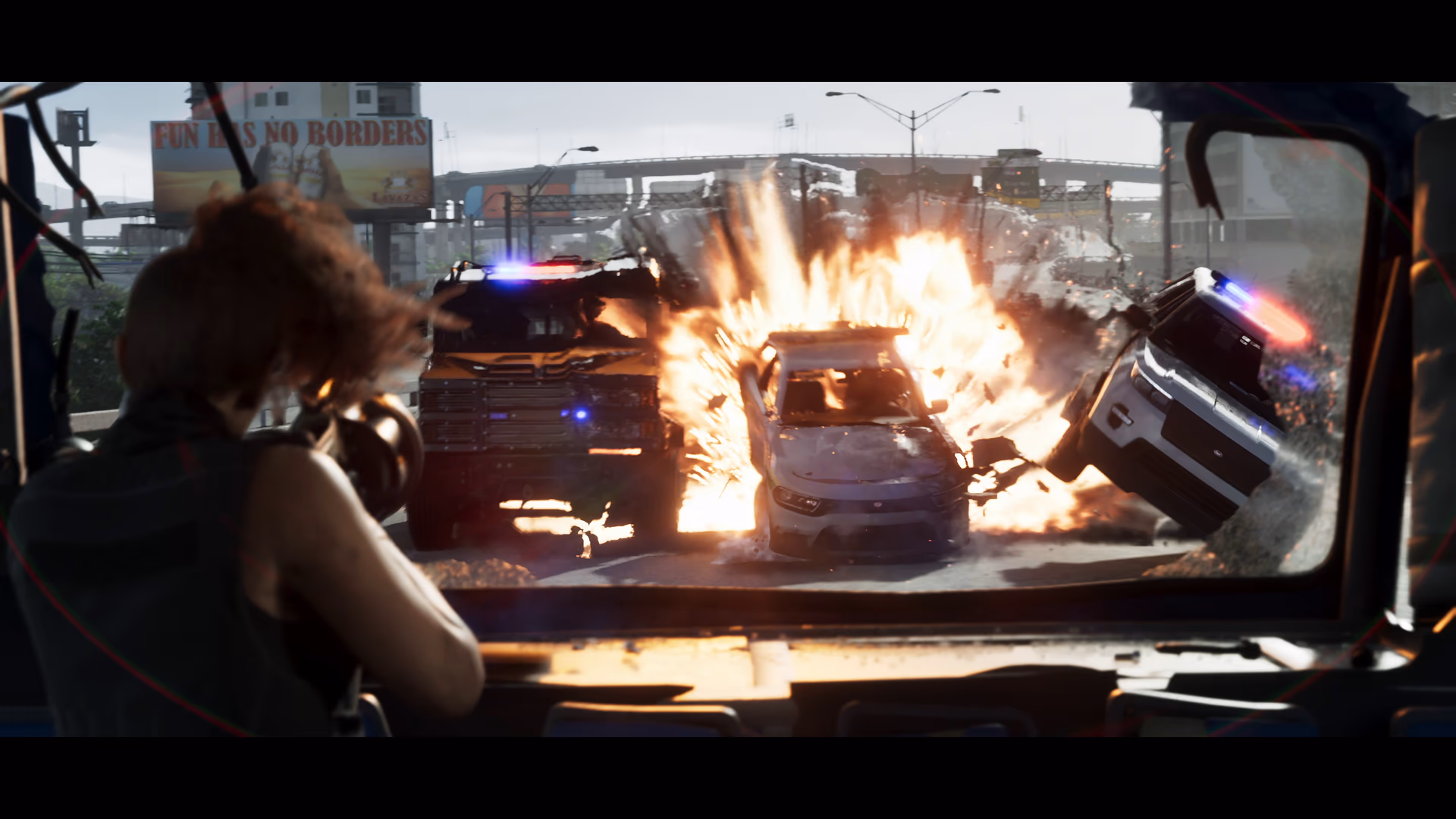 An armored emergency vehicle driving through an explosive street scene in official GTA 6 footage